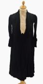 A black crepe late 1920's dress with a lace inset on bodice, button and smocking detail on sleeves