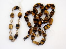 Tiger's eye and gold-coloured metal bracelet, the polished tiger's eye stones interspersed by gold-