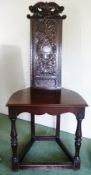A mahogany hall chair with carved high back, on turned supports