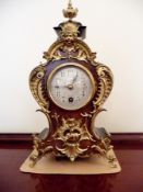 A reproduction French-style gilt metal mounted mantel clock, 31cm high