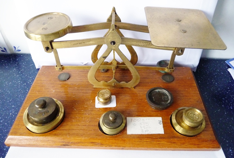 Brass letter scales with weights, on oak plinth base