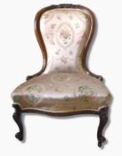 A Victorian mahogany framed spoonback lady's chair on carved cabriole legs