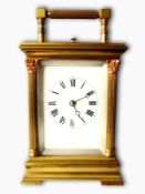 A French brass five glass carriage clock having reeded corinthian columns to corners, bracket feet