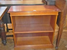 A modern stained wood two-tier bookcase on plinth base, 74cm wide