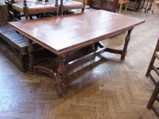 An oak refectory draw leaf dining table, with six plank top with clisset ends raised on baluster
