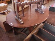 An early 20th century stained wood oval dining table, on spirally twist supports united by