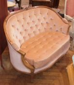 A French-style two-seater sofa, pink studded upholstery and cushion, on carved supports 

   Live