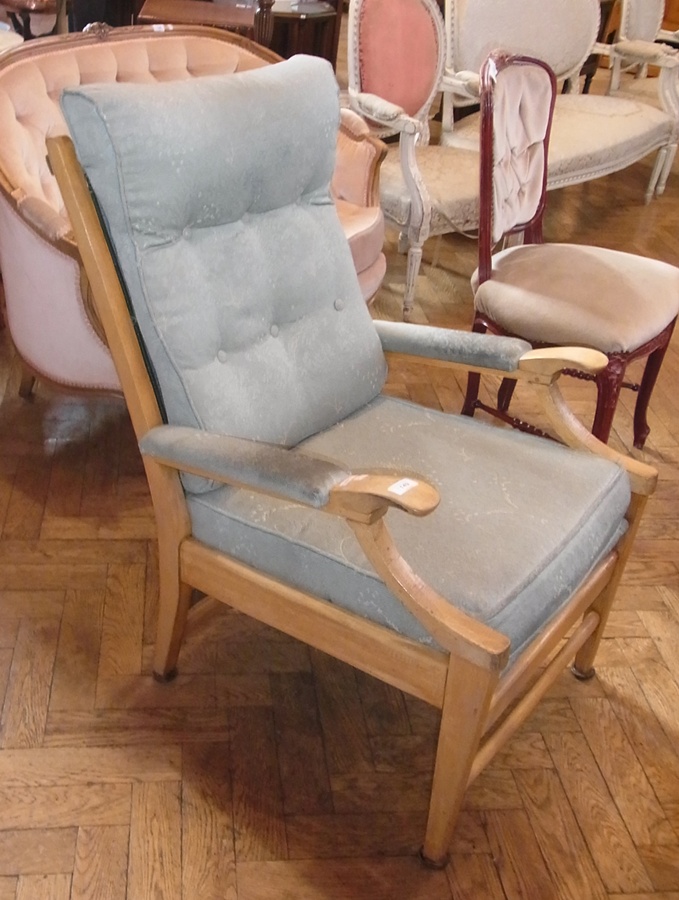 A modern Cintique chair, light wood with green upholstered back and cushion, on tapering supports