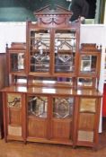 A late Victorian mahogany display cabinet with broken arch pediment, the upper central cupboard with