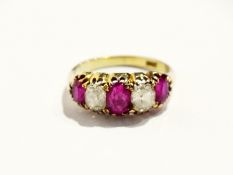 An 18ct gold ruby and diamond dress ring, set three oval rubies and two large diamonds, in claw