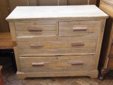 An old stripped pine chest of two short and two long graduated drawers on bracket feet, width