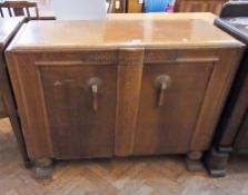 An early 20th century oak sideboard with pair of panel cupboards with Art Deco style handles, on