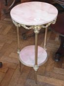 A French-style gilt metal and pink onyx/marble two-tier occasional table, circular with floral