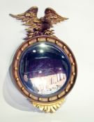 Reproduction regency-style convex wall mirror, the gilt circular frame with eagle surmount, 52.5cm