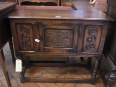Waring & Gillow oak credence-style side cabinet, with carved panelled front, on turned supports