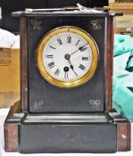 Victorian black stained marble mantel timepiece, rectangular with red marble inlay, on plinth base