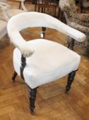 A Victorian mahogany horse-shoe armchair, in need of re-upholstery, on turned supports and castors