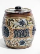 A Doulton Lambeth stoneware tobacco jar with incised floral decoration, mark to base, initialled "