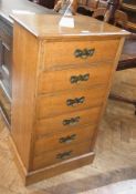 A 20th century oak tall chest of six drawers with Art Nouveau style handles, on plinth base, 54cm