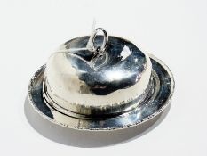 An early 20th century silver butter dish and cover with cut glass liner, the dish having bead and