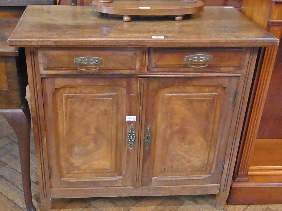 An Edwardian mahogany sideboard, two drawers and panelled cupboard enclosing shelving space, on