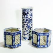 An oriental cylindrical blue and white vase, 20cm high and a pair of hexagonal baskets, 9cm high,