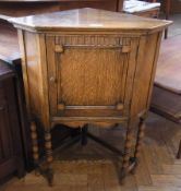 An early 20th century oak small corner cupboard, panelled door enclosing cupboard space, on beaded