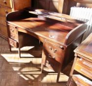 A 20th century "Britsim" roll-top desk with an arrangement of six drawers around the kneehole,