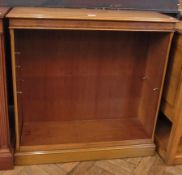 A reproduction walnut bookcase on plinth base, 90cm wide