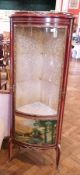 A reproduction mahogany bow front corner vitrine with bow front glazed cupboard and decorative panel