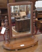 A Victorian mahogany swing-frame toilet mirror, rectangular, on spirally twist support, oval base