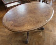 A Victorian inlaid oval and burr walnut veneered loo table, 137 x 104cms, on raised turned and