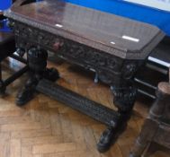 A Victorian renaissance-style carved oak side table, rectangular with cut-off corners, having lion