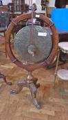 A Victorian carved oak floor-standing dinner gong, the circular wooden frame with acorn finial