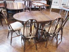 A Georgian-style oak oval gate-leg dining table, 92cm wide x 154cm long and six oak dining chairs on