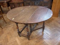 An 18th century oak fall-flap gate-leg table on baluster turned supports, 114cm x 138cm