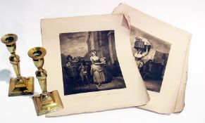 A pair of brass candlesticks and prints "Cry's of London"