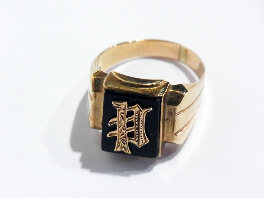 A 14ct gold and black onyx signet ring, embossed and monogrammed
