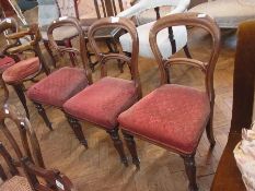 A set of three Victorian mahogany dining chairs, hoop backed, red upholstered seat, on turned