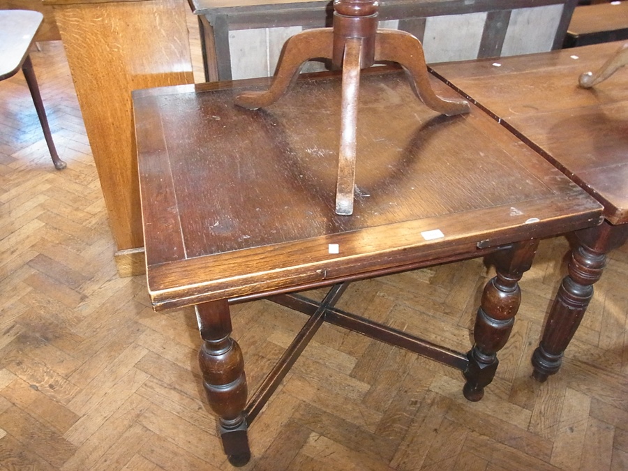 A 20th century oak extending dining table, on turned supports united by stretchers, 90cm wide
