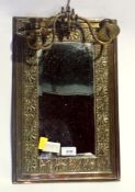 An embossed brass wall mirror with triple-sconce and a gilt painted wooden mirror with pierced