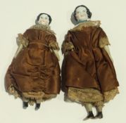 Two Victorian china shoulderhead doll's house dolls in brown silk and lace dresses