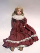 A bisque-shoulderhead doll impressed 7 1/2 with blue sleeping eyes, open mouth, soft body with
