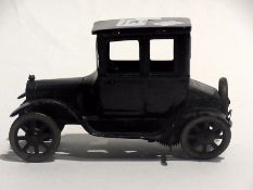 A Bing tinplate clockwork model of an early motor car in black enamel, length 16cm