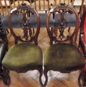 Pair Victorian walnut dining chairs, each with oval foliate scroll carved ornate back, stuffover