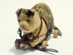 A pull-along Once plush bodied model of a cat on wheels with leather lead, 24cm long