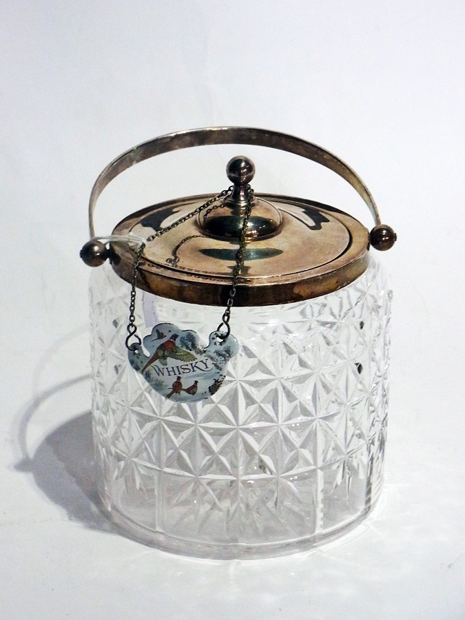 A cut glass biscuit barrel with silver mounts, lid and hoop handle, Birmingham 1909 together with an