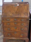 Reproduction walnut small bureau, the sloping fall-front having herringbone inlay, enclosing