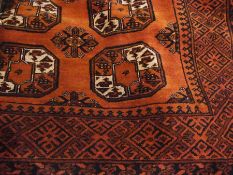 Persian style wool rug, brown ground with central medallions in black and cream, 202cm x 148cm