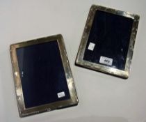 A pair of modern silver photograph frames with ribband border, 21cm x 16cm